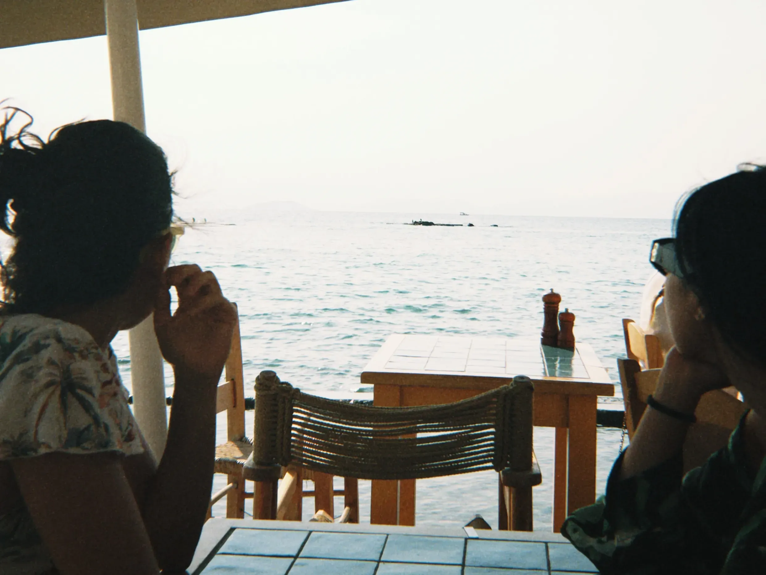 I celebrated my 30th birthday with friends in Greece last week. Photo by Xiao Wang. Two people looking out at the sea with their backs to the camera.